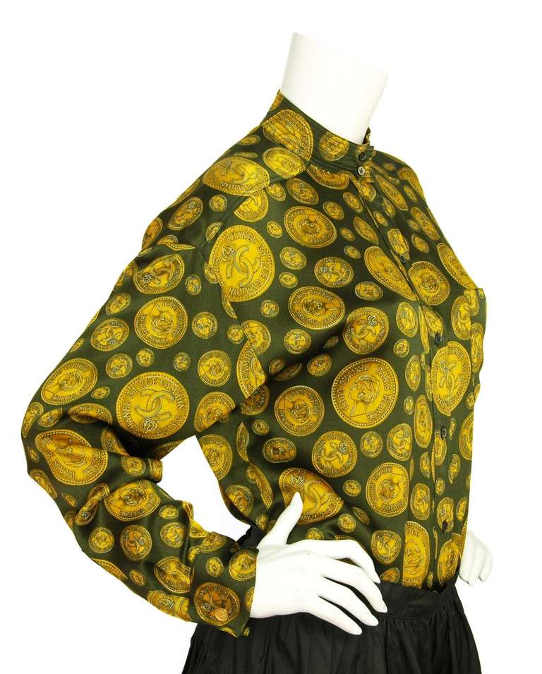 Chanel Green/Gold Silk Blouse W/Chanel Coin Print-Sz Small

    Composition: 100% silk
    Front pocket
    Front button closure w/ button up collar
    Goldtone CC coin cufflinks
    Loose fit
    Labeled 