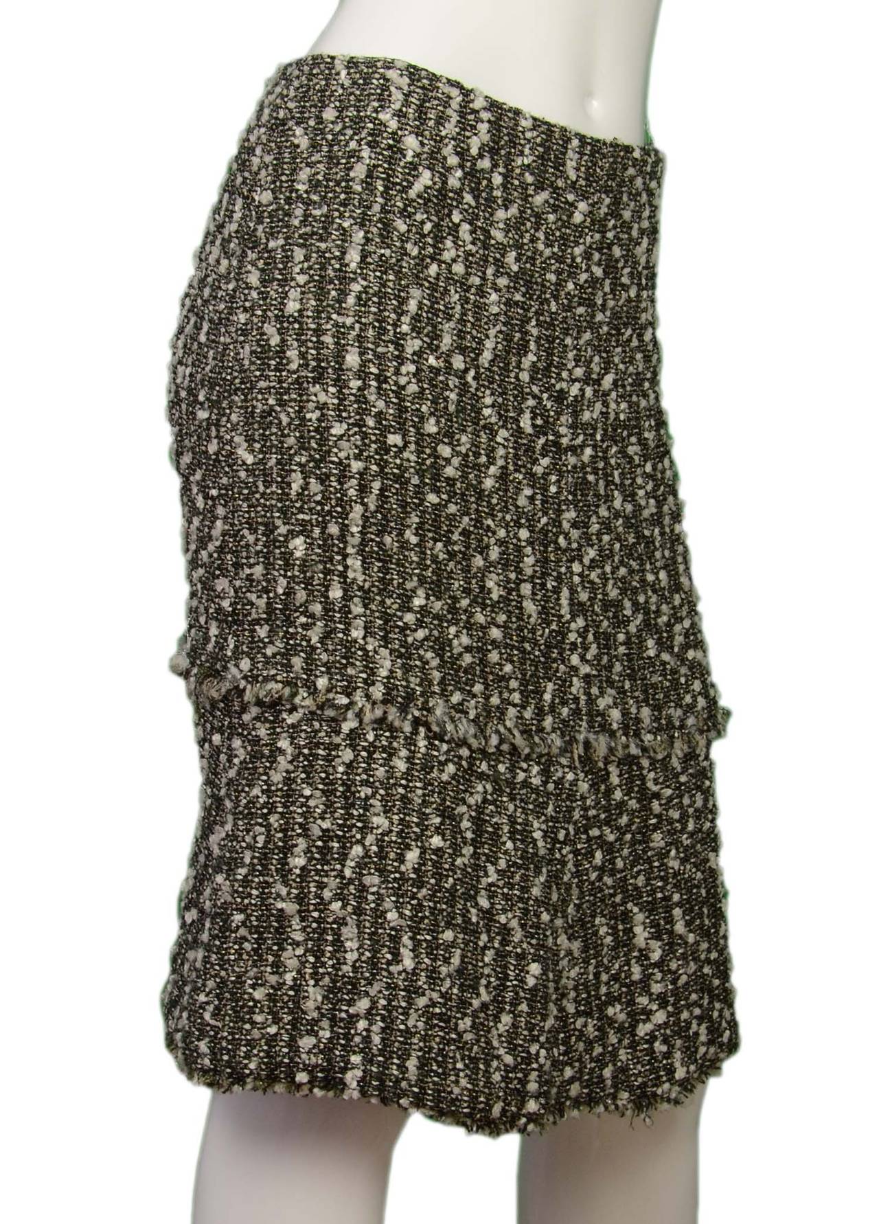 Chanel Black & White Tweed Trumpet Skirt
Features silver/sparkle thread woven into tweed to give a hint of glitter to the look

    Made in: France
    Year of Production: 2004
    Color: Black and white
    Composition: 46% rayon, 27% nylon,