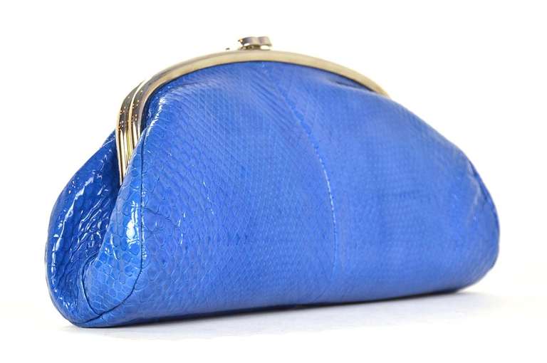 A classic style in a hard to find color and material!
c.2009
Timeless clutch construction with silver tone frame.
Silvertone CC snap closure at top.
Made in a stunning cobalt blue python.
Python is glazed to give the appearance of patent