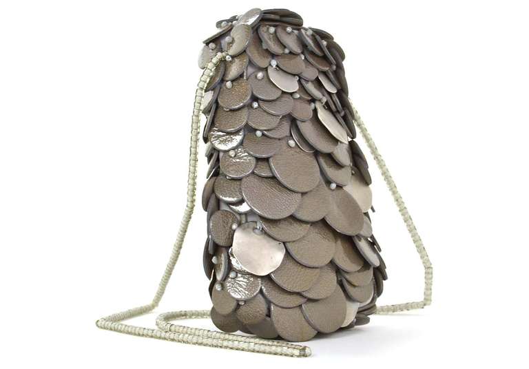 Giorgio Armani Grey Metal/Leather Circle Bag W/Beaded Shoulder Strap

    Made in Italy
    Materials: silvertone metal, leather
    Features layers of circles with side zipper closure
    Can be worn on shoulder or crossbody
    Labeled