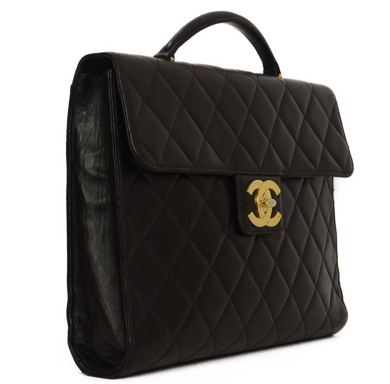 Chanel Vintage 90's Black Quilted Lambskin Attache 
Features large CC twist lock closure

    Made in: France
    Year of Production: 1994-1996
    Color: Black and goldtone
    Hardware: Goldtone
    Materials: Leather and metal
    Lining: