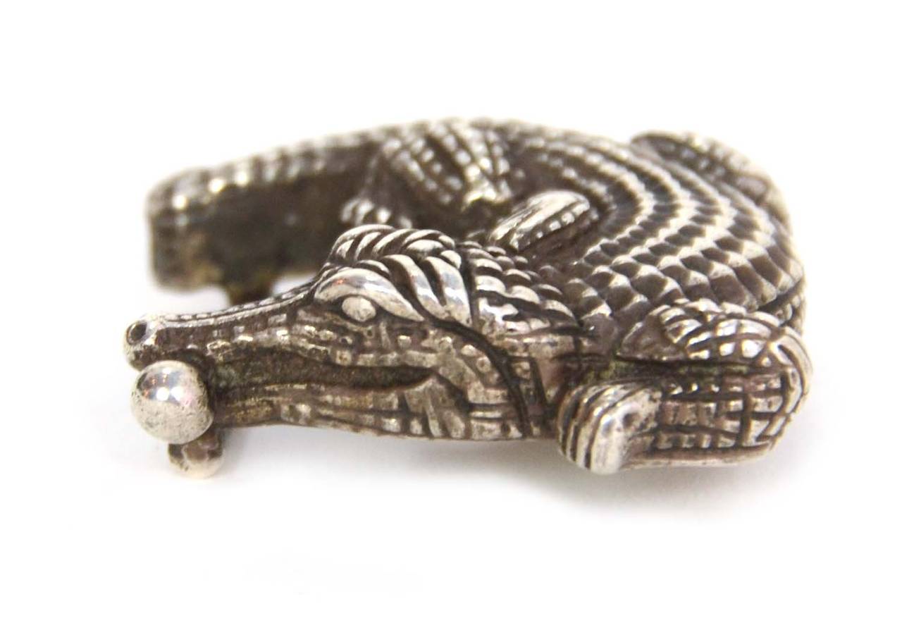 Barry Kieselstein-Cord Sterling Classic Alligator Tiny Belt Buckle
Made in: U.S.A
Color: Silver
Materials: Sterling silver
Serial Number/Date Stamp: 151 B.Kieselstein-Cord
Opening/Closure: N/A
Overall Condition: Excellent with the exception of