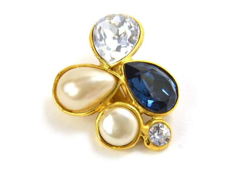 Chanel Vintage '86 Crystal Brooch & Earrings Set
Made In: France
Year of Production: 1986
Stamp: 2 CC 6
Closure: Brooch- pin back closure, Earrings- clip on
Color: Navy, ivory and goldtone
Materials: Metal, faux pearls, and crystals
Overall