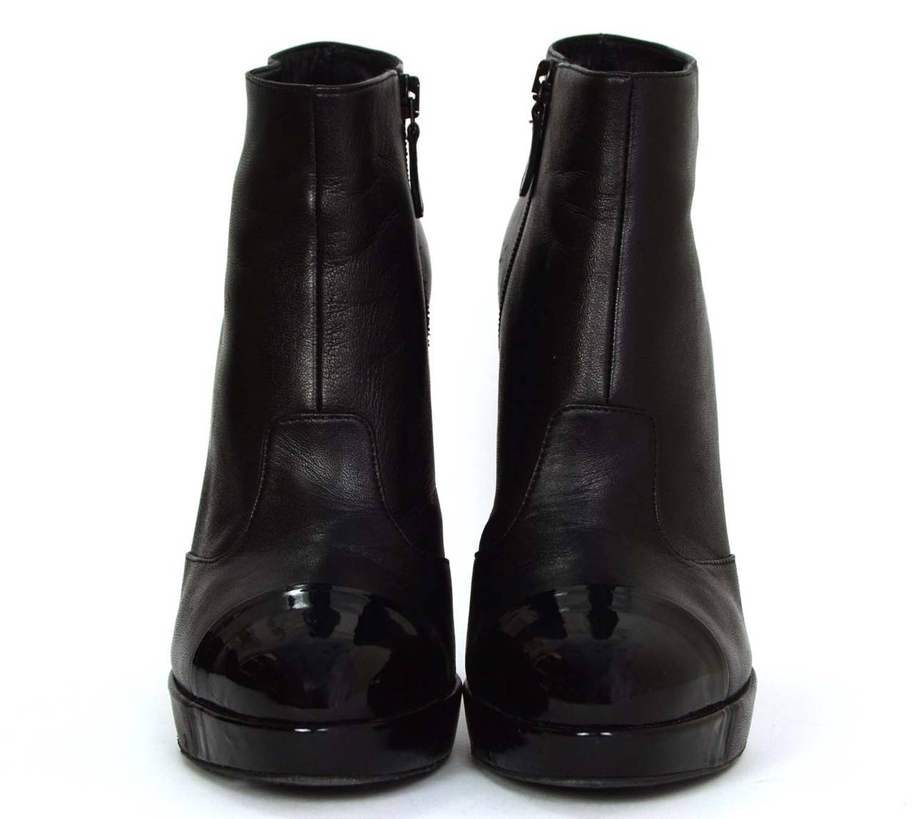 Chanel Black Leather Platform Ankle Boots
Features black patent covered toes and silvertone CC's at back of inner ankle
Made in: Italy
Color: Black
Composition: Leather
Sole Stamp: CC MADE IN ITALY 39
Serial Number/Date Code: D