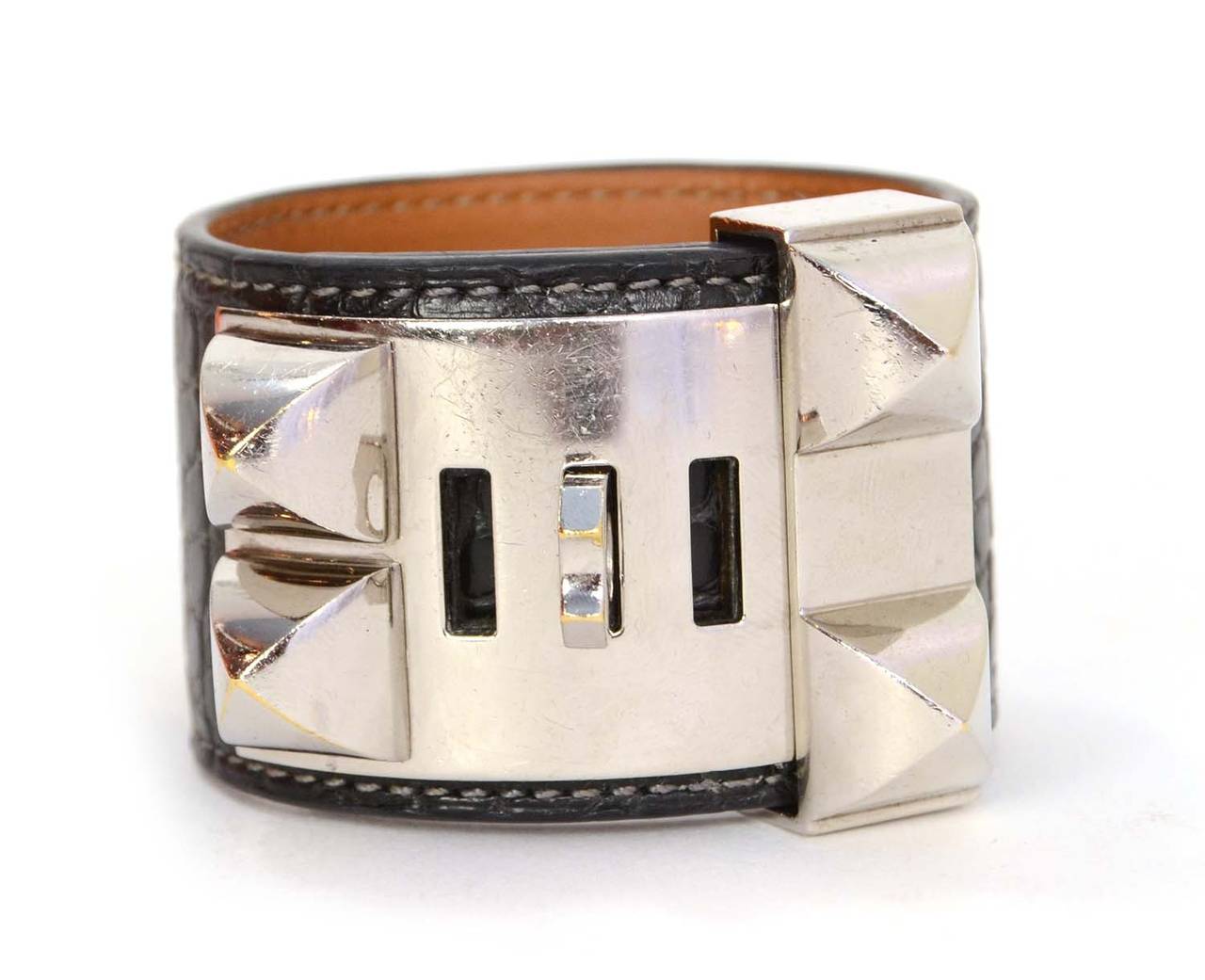 Hermes Graphite Crocodile Collier De Chien CDC Cuff
Made in: France
Year of Production: 2012
Stamp: P stamp in square
Closure: Stud and notch closure
Color: Graphite and silvertone
Materials: Crocodile, leather lining and palladium