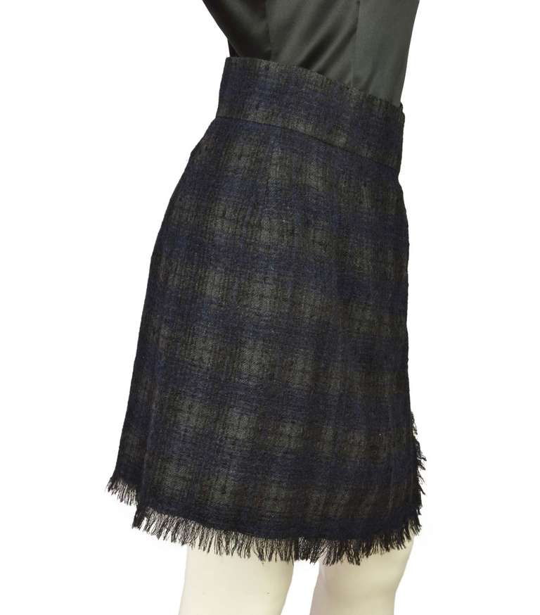 Chanel Navy/Grey Wool Wrap Skirt W/Fringe Trim Sz 4

    Made in Italy
    Composition: 45% wool, 45% alpaca, 10% nylon
    One side pocket
    Side button closure
    Labeled 