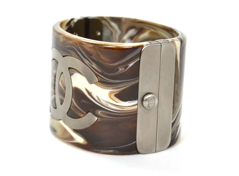 Chanel Brown Marble Design Cuff

    Age: c. 2010
    Made in Italy
    Materials: resin, brushed silvertone metal
    CC logo in brushed silvertone metal
    Slide and push in lock
    Stamped 
