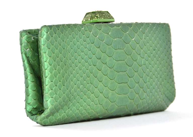 Chanel Green Python Clutch W/Rhinestone Clasp Rt. $3,200

    Age: c. 2013
    Made in Italy
    Materials: snakeskin, rhinestones
    Opens to a satin lining with a slip pocket
    Two open pockets on each side
    Closes with a rhinestone
