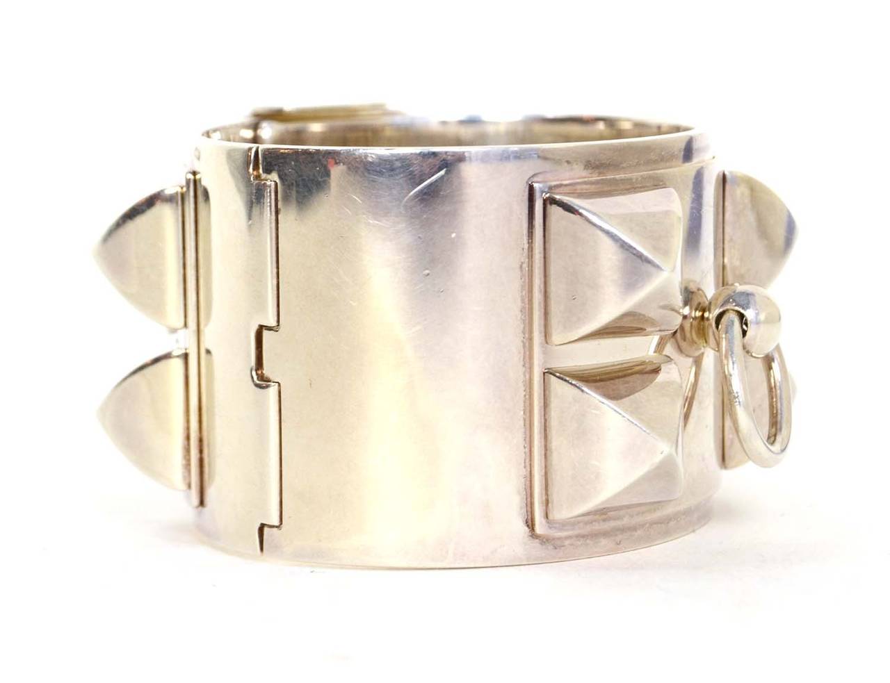 Hermes Sterling Silver Collier De Chien CDC Cuff Bracelet
Features iconic CDC pyramid studs and door knocker accent
Made in: Not given
Stamp: Ag925 A*D
Closure: Hinge opening with hook lever closure
Color: Silver
Materials: Sterling