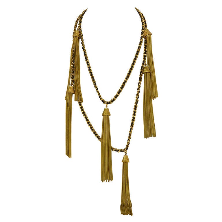 Chanel RARE Vintage '94 Leather & Chain Tassel Necklace
Features gold CC tassels throughout with leather woven chain

Made In: France
Year of Production: 1994
Color: Gold and black
Materials: Leather and metal
Closure: Hook closure
Stamp: 94 CC