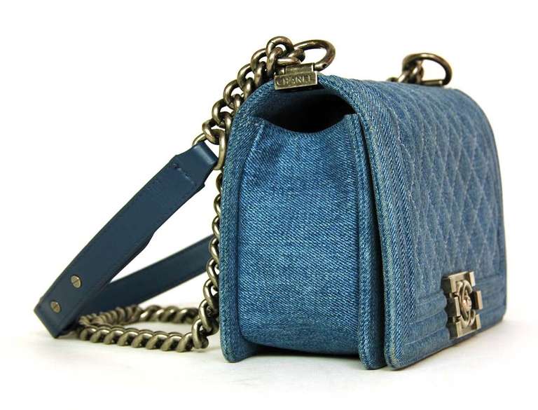 CHANEL Blue Denim 'Boy' Bag W. Silver Hardware 2013

Made in France

Materials: blue denim (cotton), leather, silver hardware.

Features classic rectangular 'Boy' shape with silver lego style CC closure and pushlock on flap. Strap is half