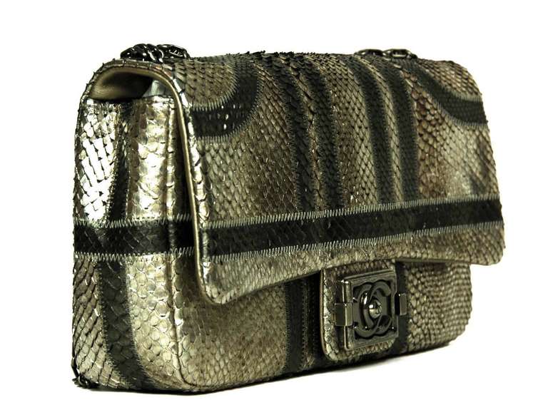 Chanel Silver and Pewter Python Flap Bag
c.2012
Made in metallic pewter and bronze Python leather with antiqued silvertone hardware.
Double bijoux chain strap.
CC push lock closure

Stamped: CHANEL MADE IN ITALY

Hologram sticker reads: