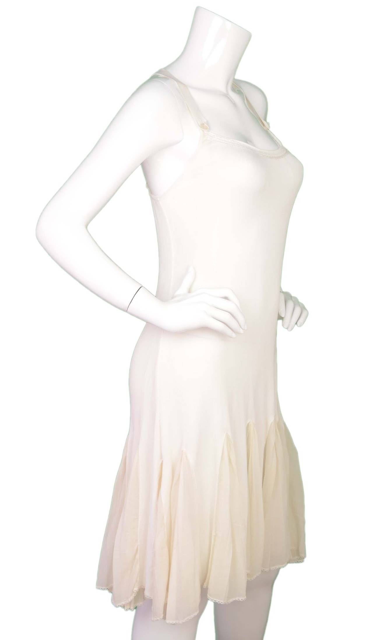 Chanel Ivory Godet Criss-Cross Dress
Features button front shoulder straps
Made in: France
Year of Production: 2004
Color: Ivory
Composition: 100% rayon
Lining: Ivory, 70% silk, 30% polyester
Closure/opening: Pull on
Exterior Pockets: