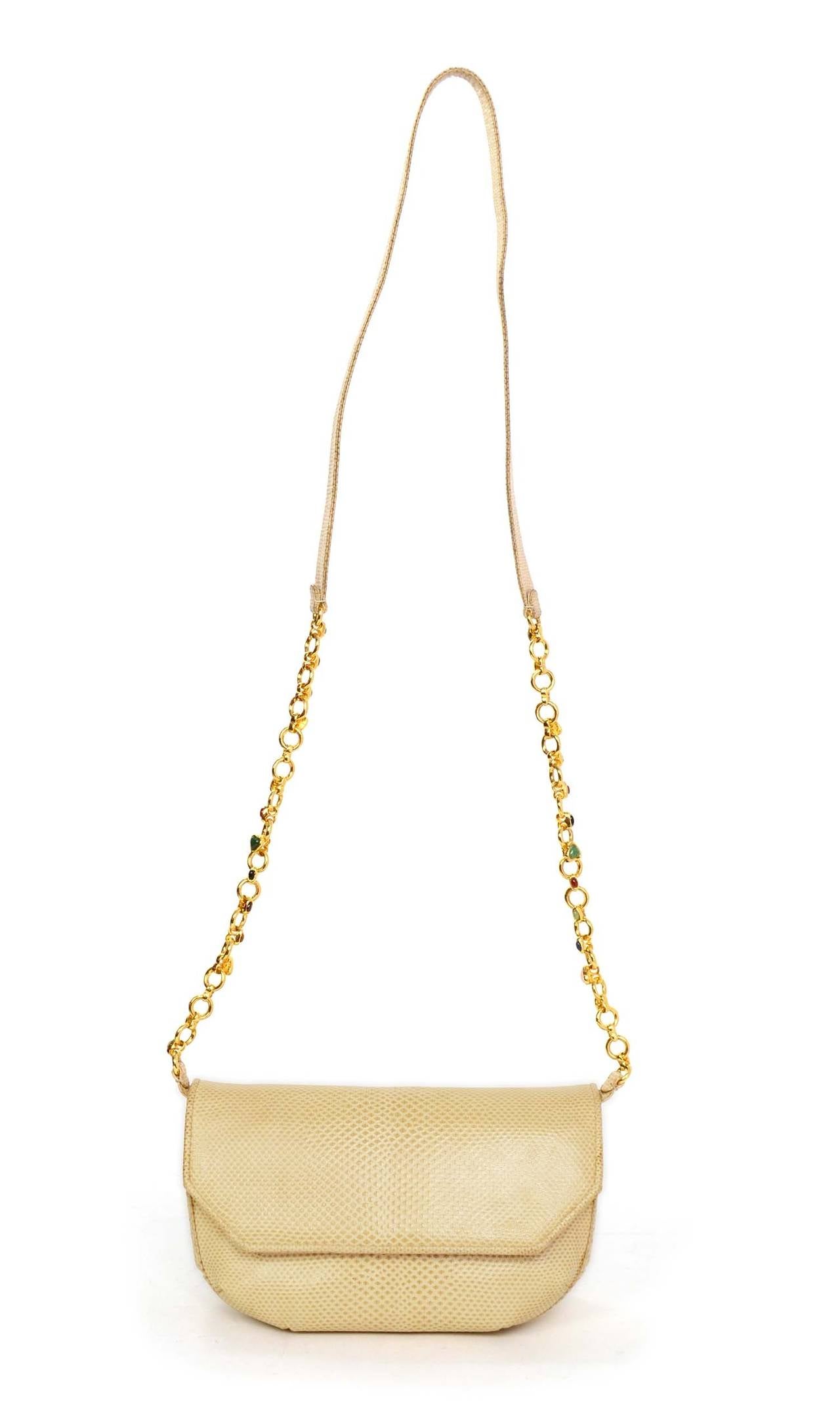 Judith Leiber Beige Lizard Evening Bag
Features multi-colored stones on chain link shoulder strap
Made in: Not given
Color: Beige and goldtone
Hardware: Goldtone
Materials: Lizard skin and metal
Lining: Beige textile
Closure/opening: Flap top
