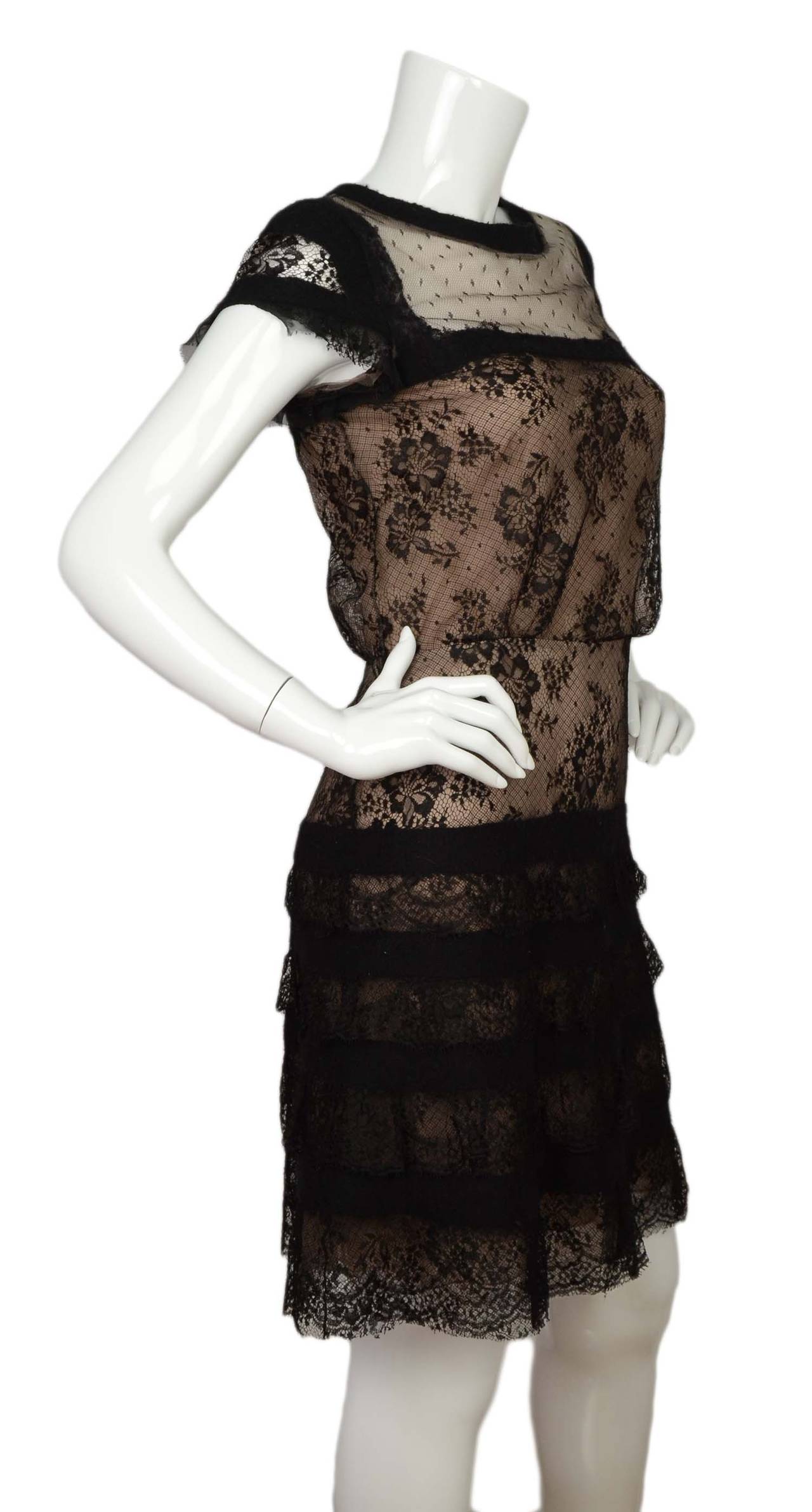 Valentino Black Lace Cap-Sleeve Cocktail Dress
​Features wool fused trim around neckline and sleeves 
Made in: Italy
Color: Not bold
Composition: 85% viscose, 15% nylon
Lining: Beige, 100% silk
Closure/opening: Back center zipper