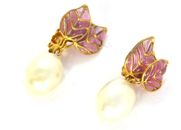 Chanel Clip On Pearl And Gripoix Earrings

    Age: c. 1988
    Made in France
    Materials: faux pearls, gripoix, goldtone metal
    Three-leaf pink gripoix design with hanging pearl
    Stamped 