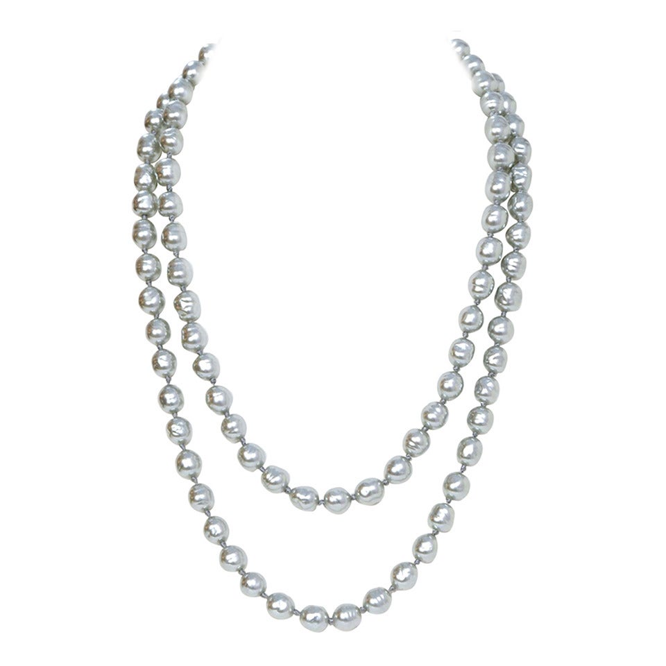 Chanel Vintage '81 Long Grey Pearl Necklace

Year of Production: 1981
Color: Grey-silver
Materials: Faux pearls
Stamp: CHANEL CC 1981
Closure: None
Overall Condition: Excellent with the exception of light nicks to pearls
Measurements:
Length: