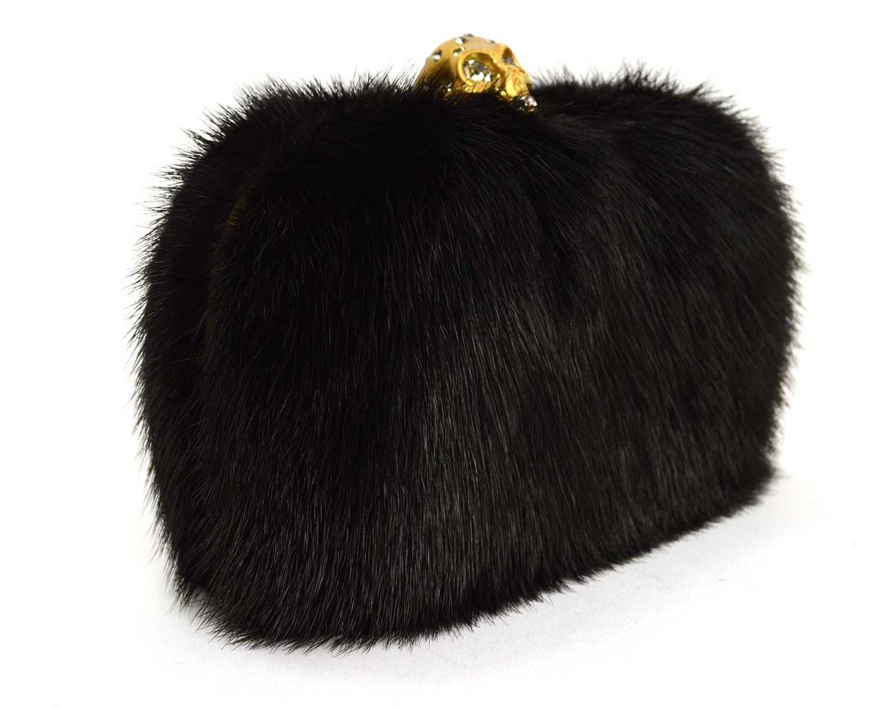 Alexander McQueen Black Fur Skull Clutch
Features rhinestone detailing throughout skull
Made in: Italy
Color: Black and goldtone
Hardware: Goldtone
Materials: Fur, metal and rhinestones
Lining: Black leather
Closure/opening: Hinge opening