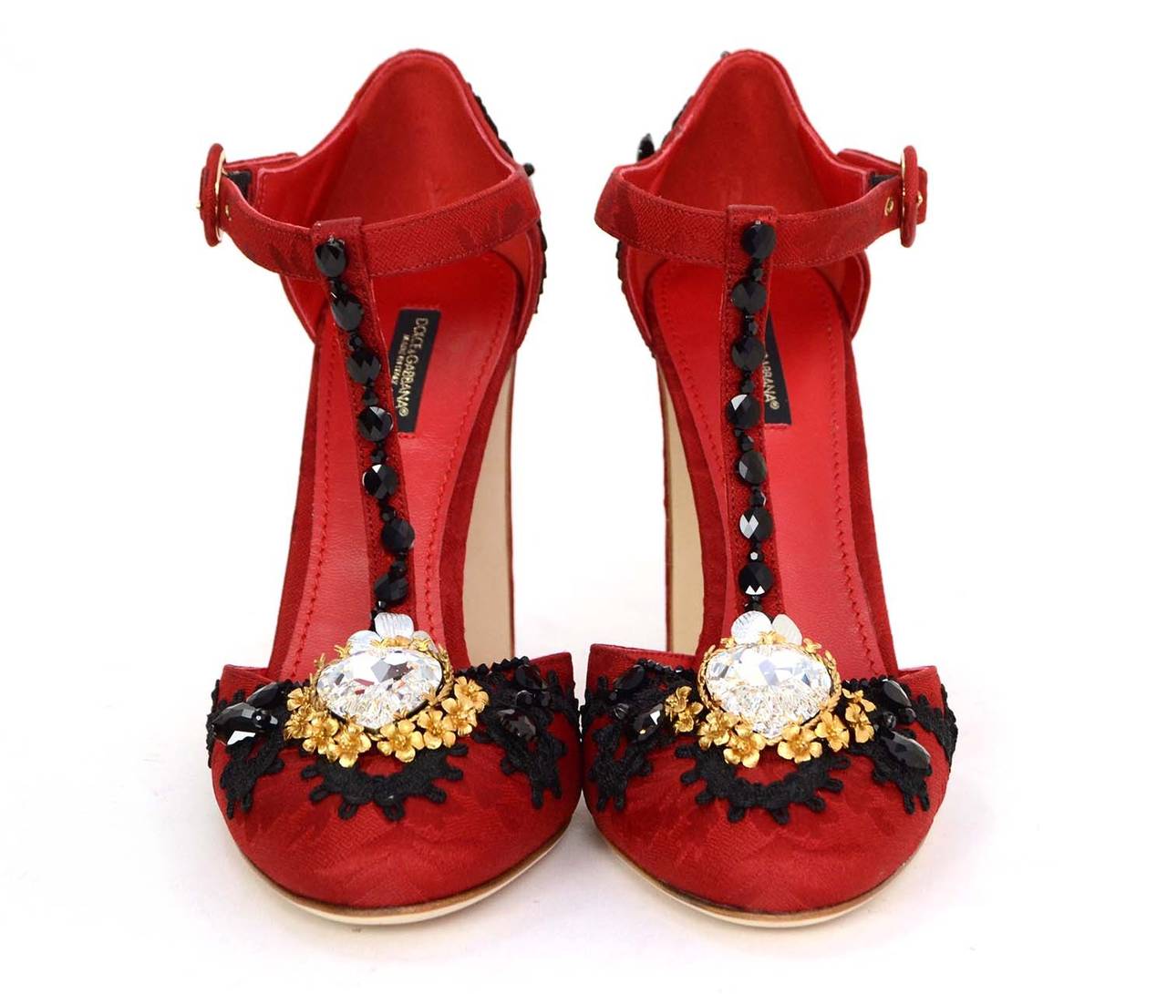 Dolce & Gabbana Red & Black Vally Jewel-Embellished T-Strap Pumps
Features large heart-shaped rhinestone at toe
Made in: Italy
Color: Red, black gold and silvertone
Composition: Lace, silk, rhinestones and metal
Sole Stamp: Dolce & Gabbana 39