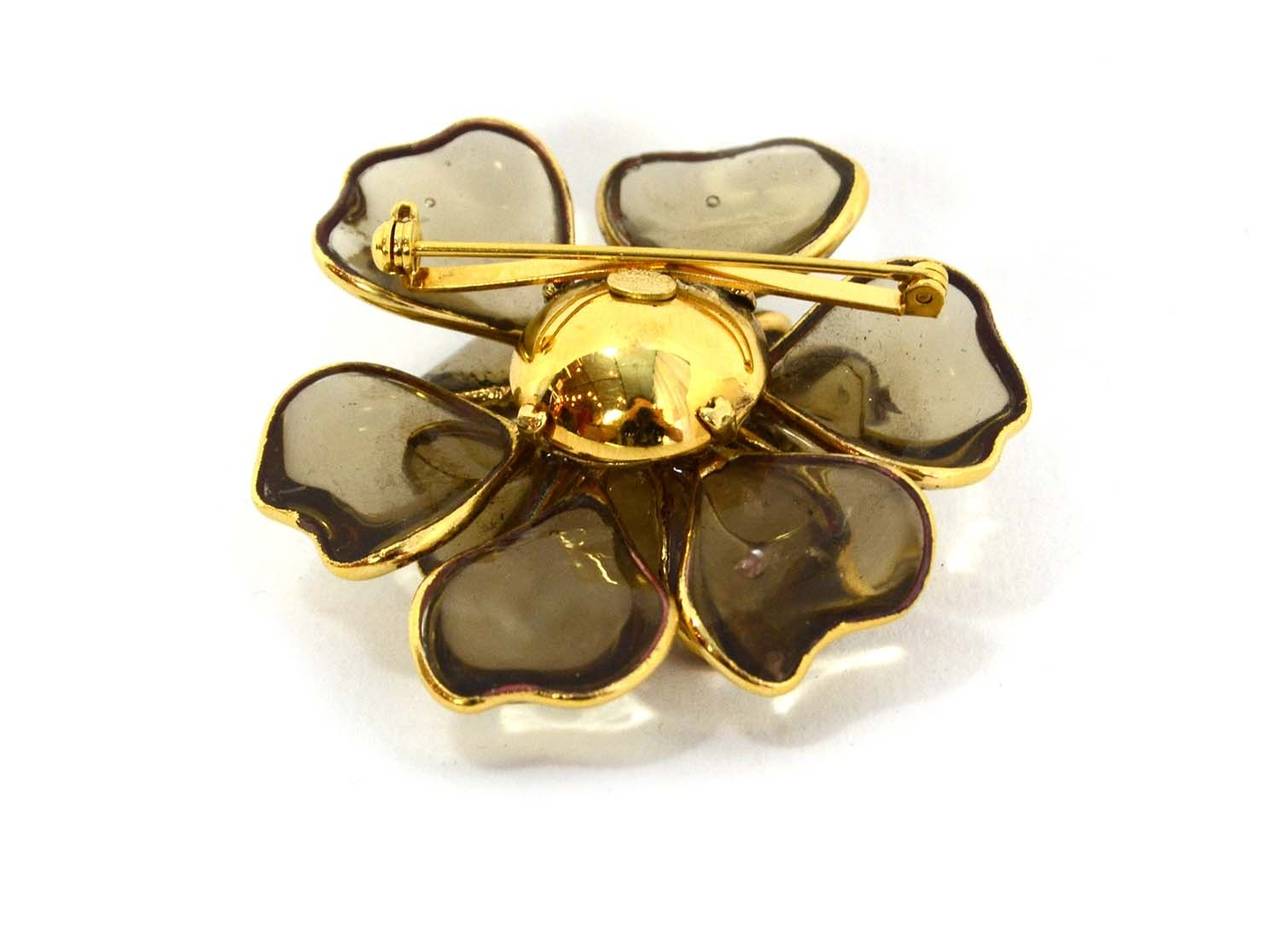 Chanel Glass & Pearl Flower Brooch
Features goldtone metal outlining each petal
Made in: France
Year of Production: 2005
Stamp: 05 CC C
Closure: Pin back closure
Color: Goldtone and ivory
Materials: Glass, faux pearl and metal
Overall