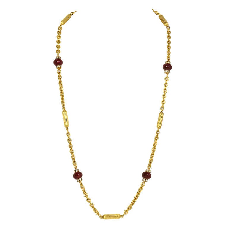 Chanel Vintage Red Bead & Rhinestone Gold Necklace
Features goldtone bars with red beads and rhinestone spacers.  Necklace can be worn long or doubled.

Made In: France
Color: Goldtone and red
Materials: Metal, beads and rhinestones
Stamp: CHANEL