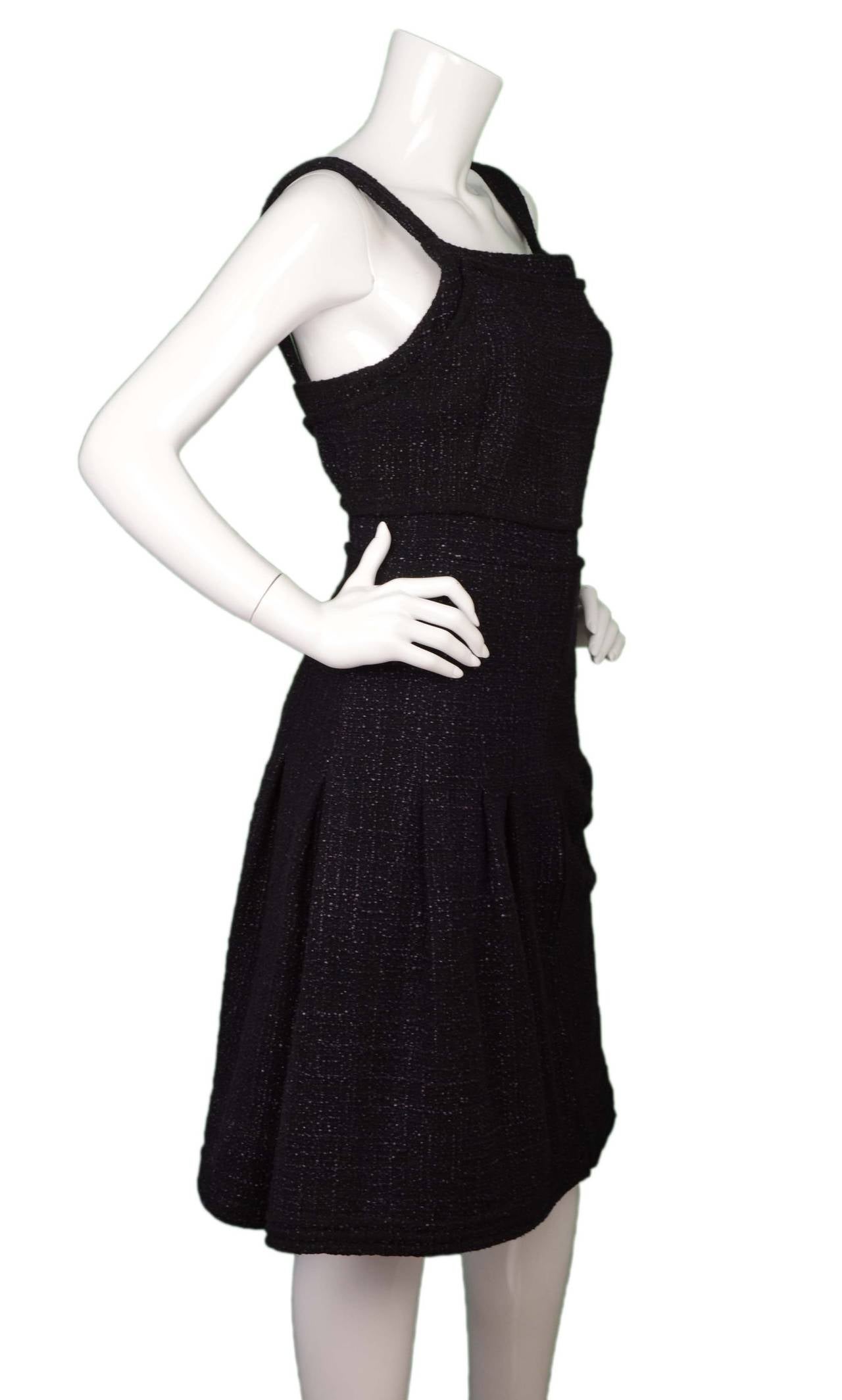 Chanel Black & Purple Tweed Pleated Dress 
Features purple stone pendant at hip
Made in: France
Year of Production: 2012
Color: Black and purple
Composition: 90% cotton, 10% rayon
Lining: Purple, 100% silk
Closure/opening: Back center zip