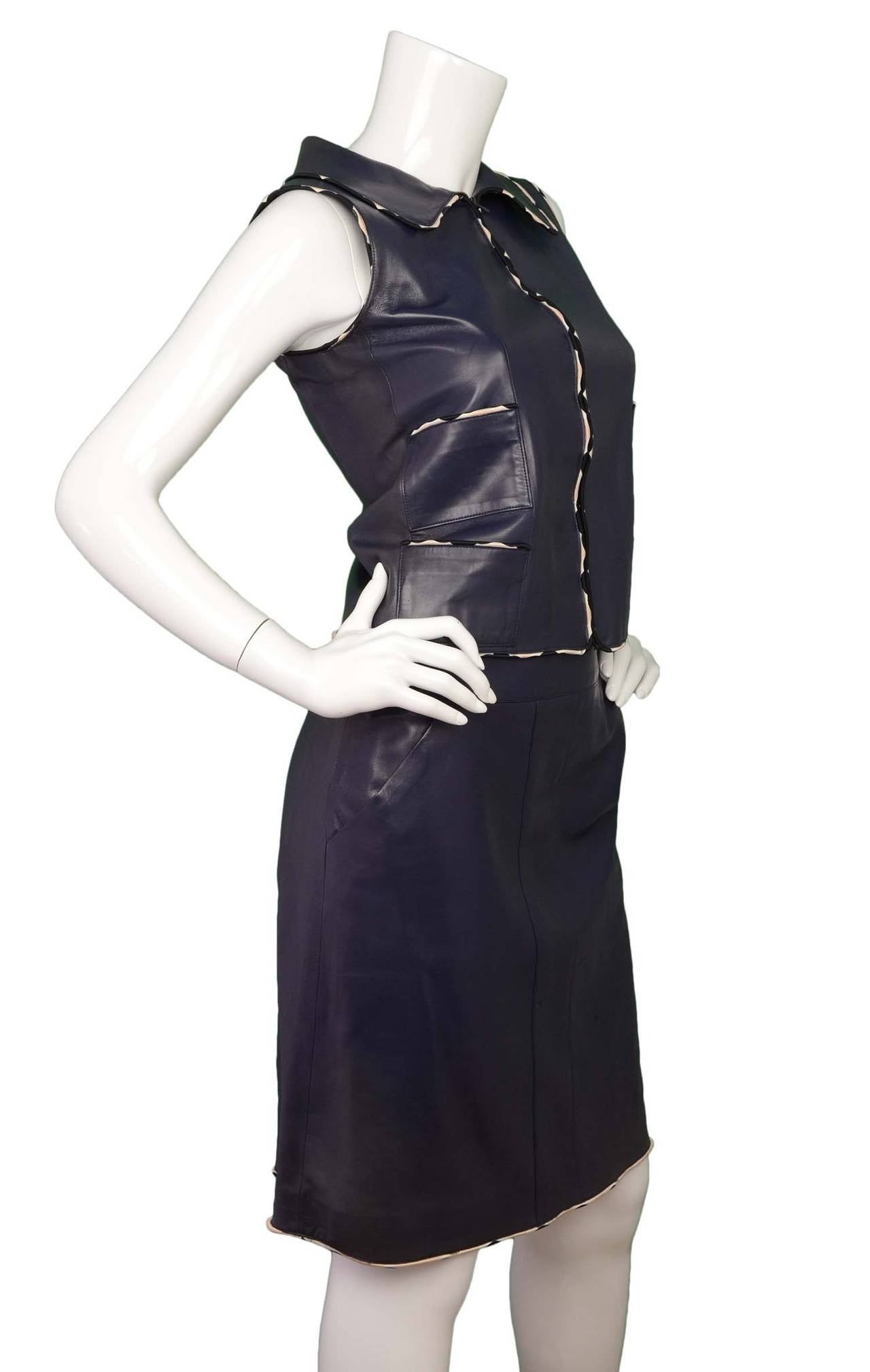 Chanel Blue Leather Sleeveless Skirt Suit 
Features silk white polka dot piping throughout both vest and skirt
Made in: France
Year of Production: 2005
Color: Navy and white
Composition: 100% lambskin
Lining: Navy, 94% silk, 6%