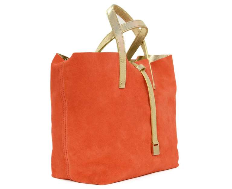 Tiffany Orange Suede/Gold Metallic Reversible Tote W/Insert Rt. $475

    Made in Italy
    Materials: suede, gold metallic leather
    Reversible to gold metallic
    Top strap over closure
    Stamped 