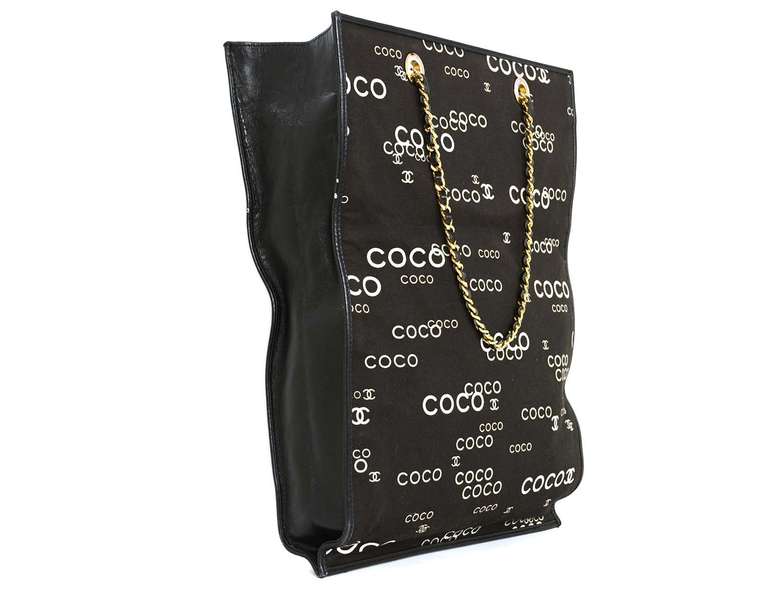 c.2002-2003
Black canvas body with black leather trim
Goldtone leather laced chain straps.
COCO logo appears throughout in white and grey.
Black textile lining
Hologram reads 7357774
6.5