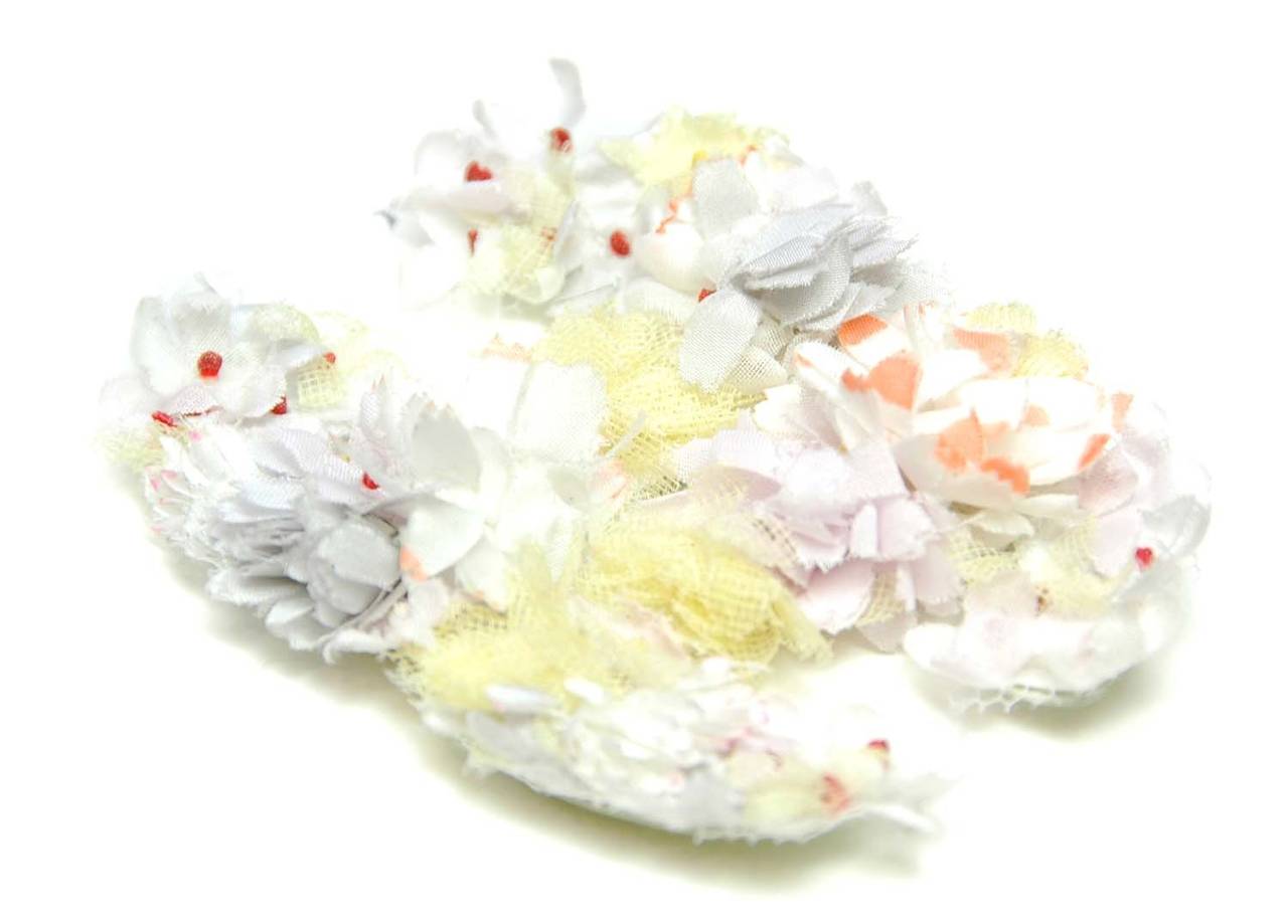 Chanel  Vintage '70s-80's Floral Appliqué CC Brooch
Made in: France
Year of Production: 1970s-1980s
Color: Lavender, white and yellow
Materials: Textile flowers and leather
Closure: Pin back closure
Stamp: Chanel CC Made in France
Overall