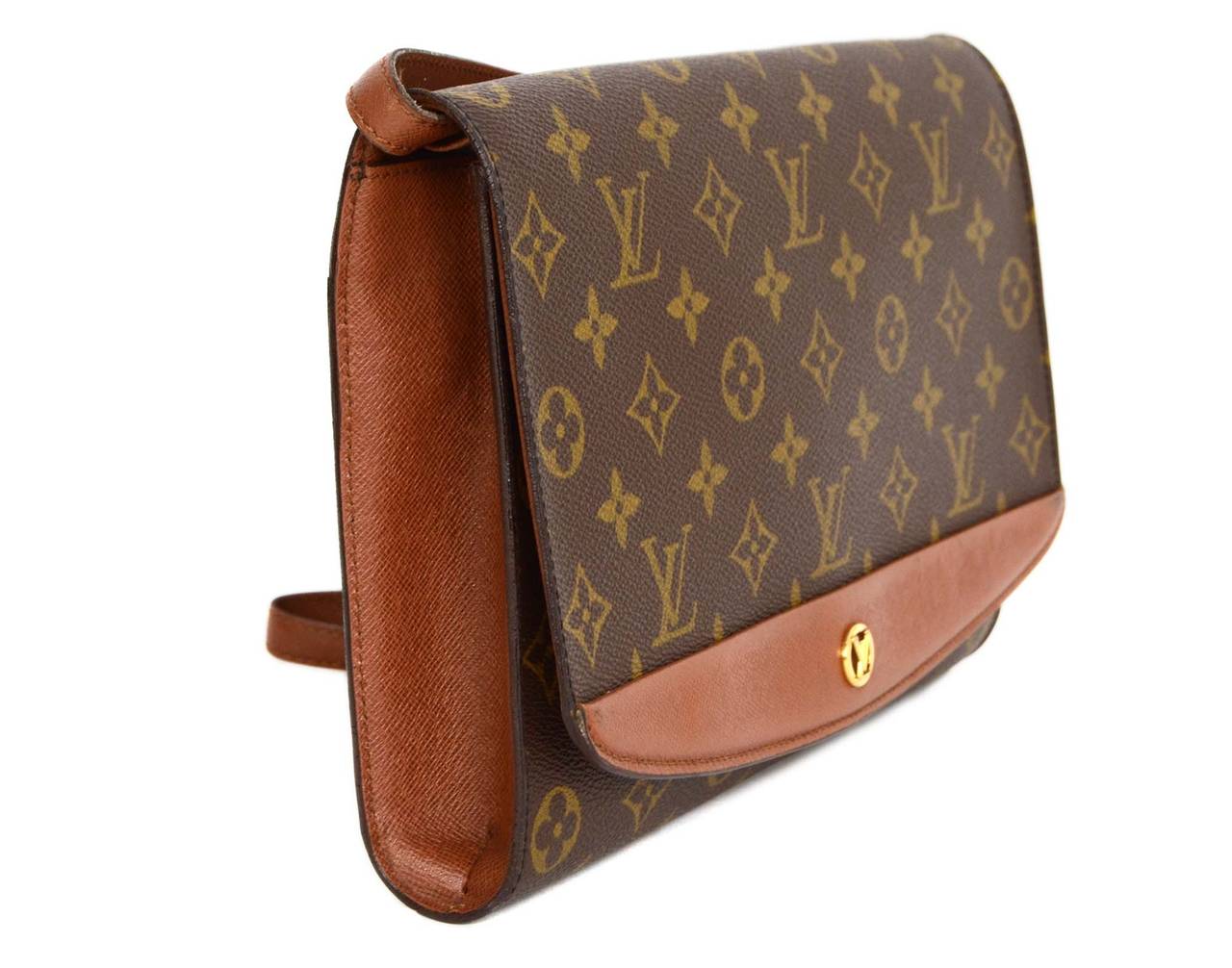 Louis Vuitton Vintage '91 Monogram Canvas Clutch Bag
Features goldtone LV on front of flap top closure

    Made in: France
    Year of Production: 1991
    Color: Brown, tan and goldtone
    Hardware: Goldtone
    Materials: Coated canvas
