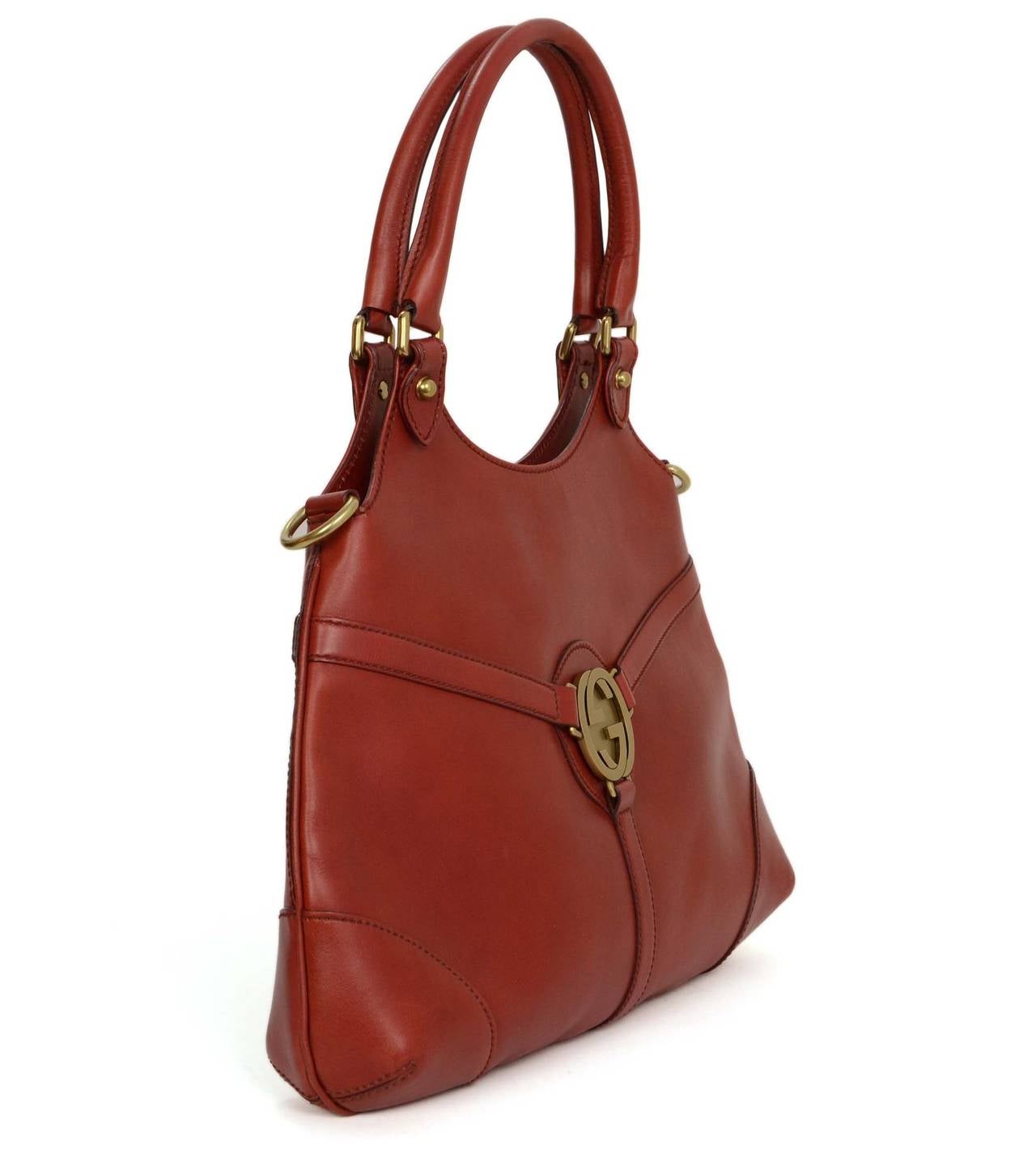 Gucci Rust Leather Shoulder Bag
Features large brass GG logo on front of bag

    Made in: Italy
    Color: Rust
    Hardware: Brass
    Materials: Leather and metal
    Lining: Rust suede
    Closure/opening: Open top
    Exterior