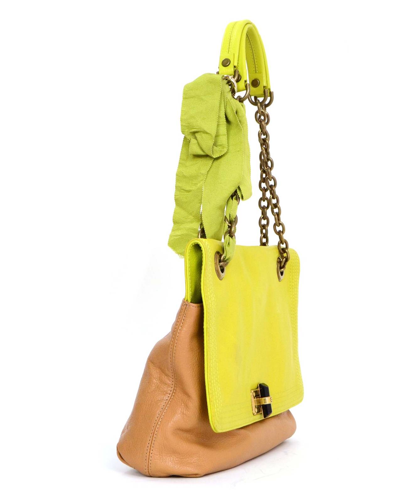 Lanvin Two-Tone Leather Happy Bag
Features green ribbon interwoven through brass chain link shoulder strap
Made in: Italy
Color: Lime green and tan
Hardware: Brass
Materials: Leather, metal and grosgrain
Lining: Black Lanvin logo printed