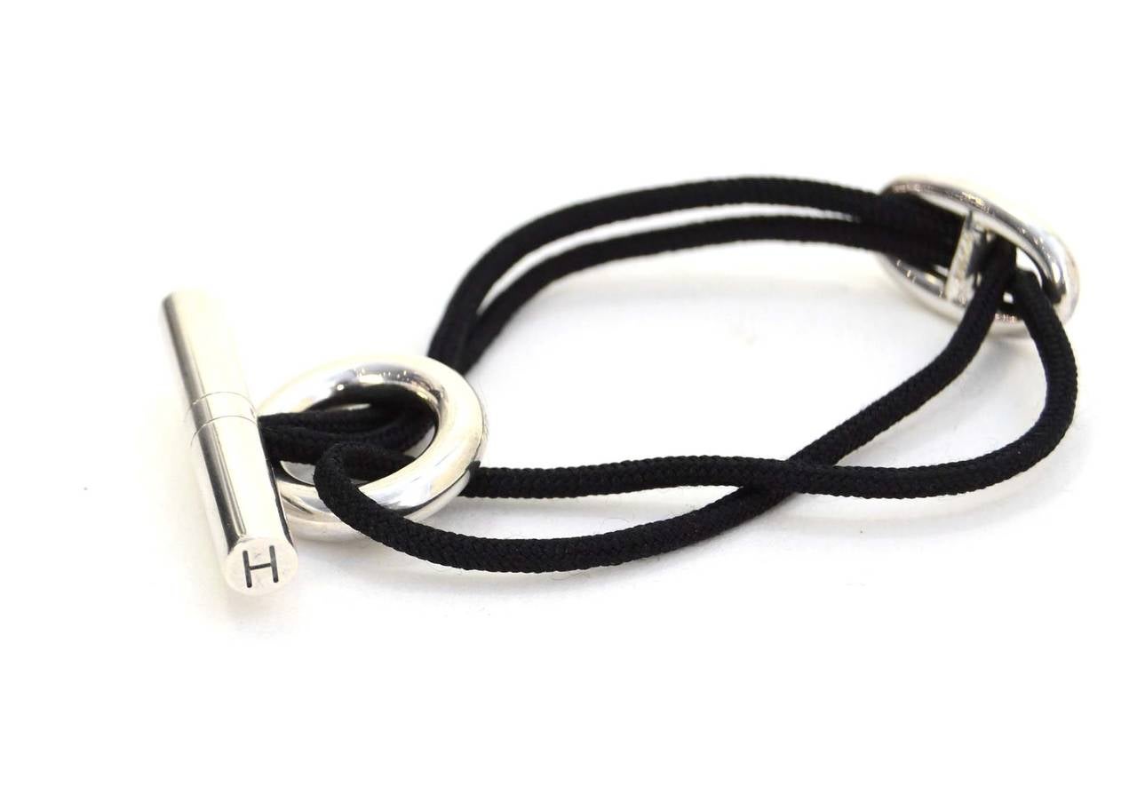 Hermes Sterling & Black Cord Skipper Bracelet
Made in: Not given- assumed to be France
Stamp: HERMES Ag925 A*D
Closure: Toggle closure
Color: Black and silver
Materials: Sterling silver and nylon cord
Overall Condition: Excellent condition