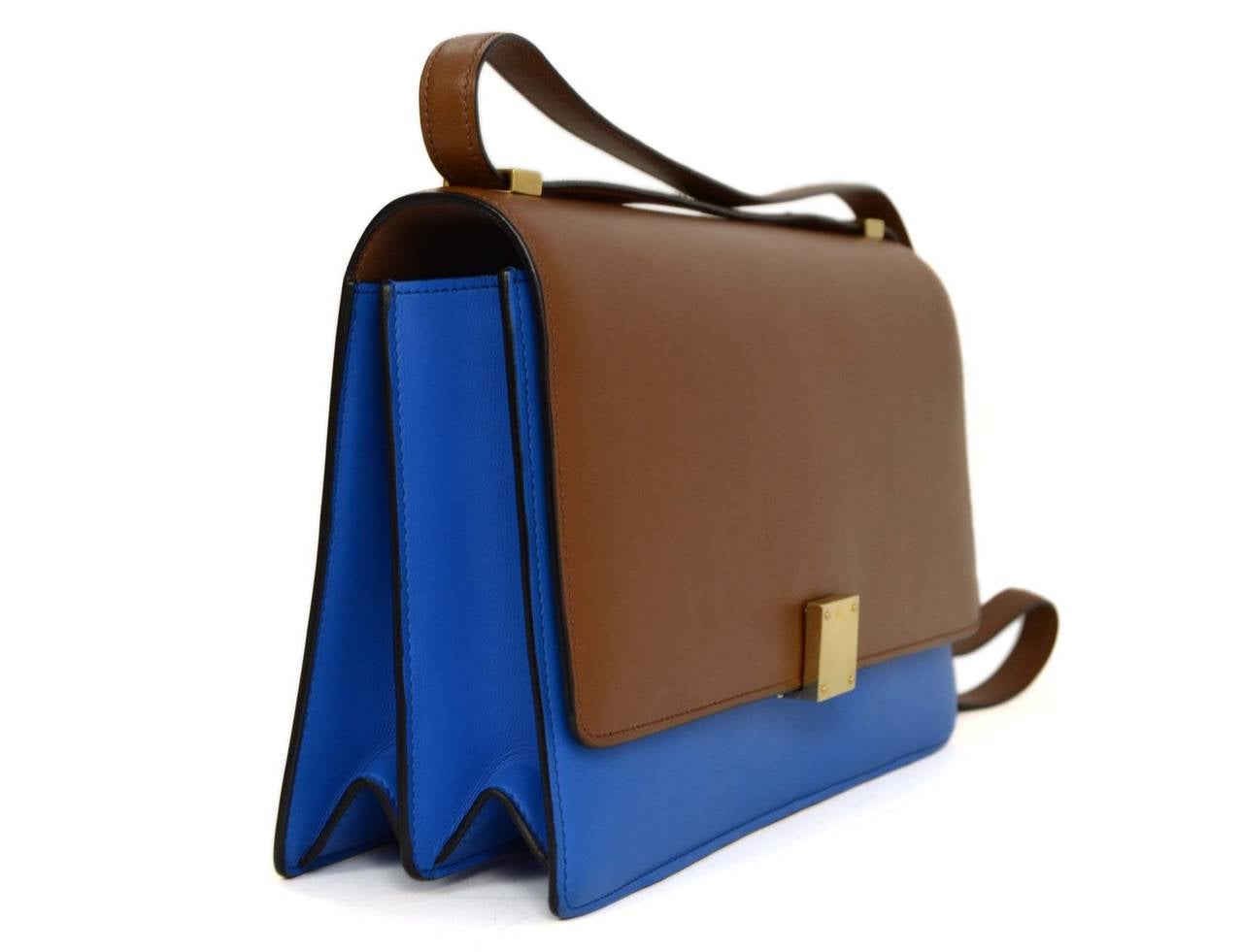 Celine Two-Tone Calfskin Medium Case Flap Bag
Features shoulder strap that can adjust from double to single to switch from shoulder bag to crossbody
Made in: Italy
Color: Cobalt, brown and goldtone
Hardware: Goldtone
Materials: Calfskin and