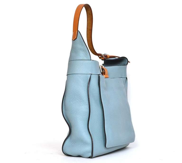 c. 2009

Sky blue Clemence leather with natural leather accents.

Features flap pocket in front and zippered pocket on the inside

Strap and buckle top closure

Blind date stamp reads 