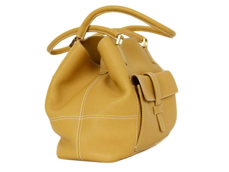 Loro Piana Mustard Leather Shoulder Bag

    Made in Italy
    Materials: leather, canvas lining
    This bag features two exterior pockets. The front pocket closes with a flap and slip through strap and the rear pocket is zippered.
    The