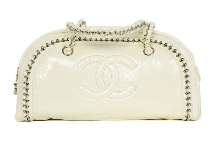 Chanel Off White Patent Leather Luxe Ligne Chain Bowler Bag

c.2007

Luxe Ligne collection

Made in Italy

Off white patent leather with silvertone hardware.

Bowler style with embedded chain.

Double patent laced chain straps.

Zip