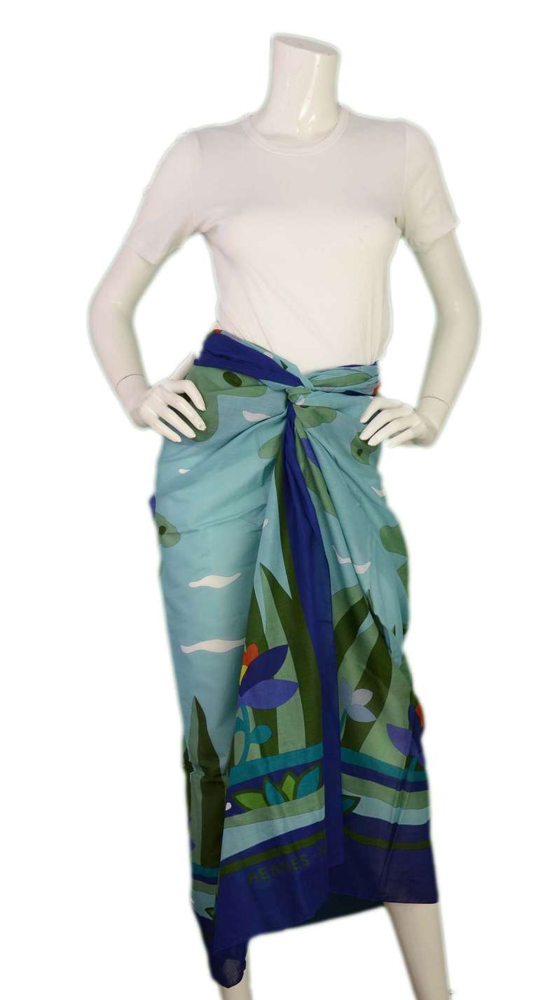Hermes Beach Pareo

    100% cotton
    Made in France
    Seascape print with flowers and lily pads
    Shades of blue and green with hints of orange
    Can be worn as a dress, skirt, scarf or shawl
    Comes in Hermes box
    58