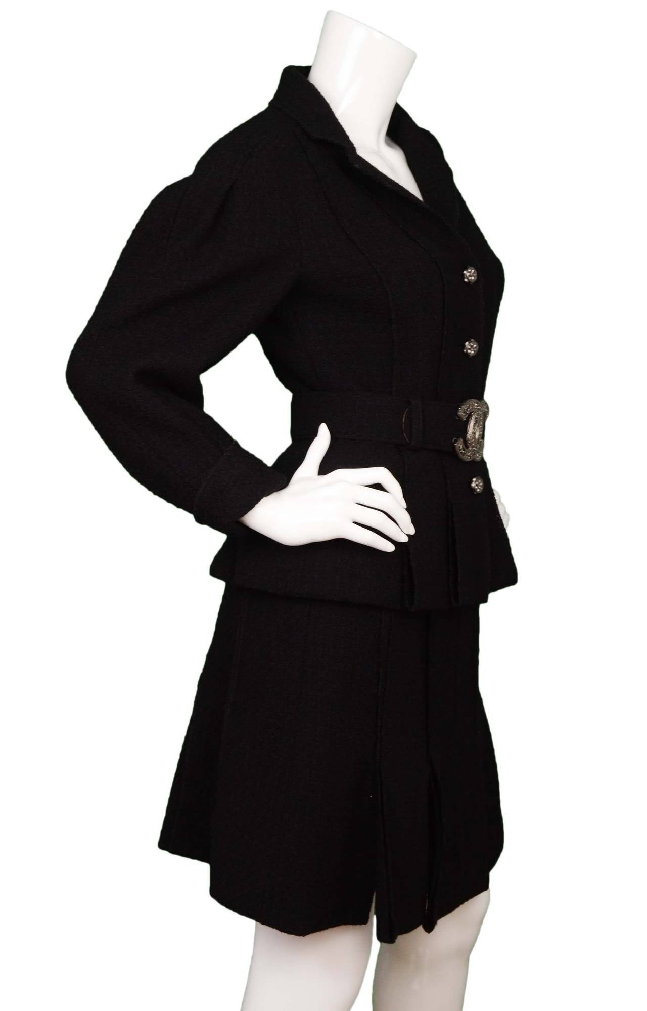 Chanel Black Boucle Wool Skirt Suit
Both skirt and jacket feature pleats throughout, belt features large silvertone CC buckle
Made in: Suit- France, Belt- Italy
Year of Production: 2008
Color: Black and silvertone
Composition: Suit- 100% wool,