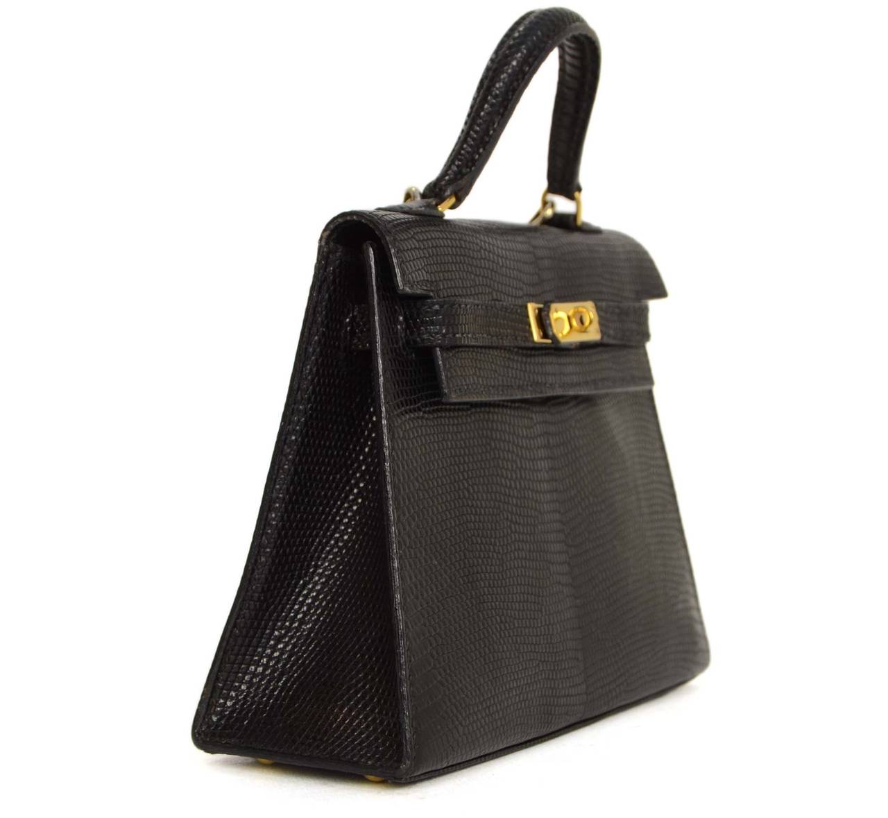 Hermes Vintage '92 Black Lizard Skin 15cm Kelly Bag
Made in: France
Year of Production: 1992
Color: Black
Hardware: Gold-plated
Materials: Lizard skin
Lining: Black leather
Closure/opening: Top flap with two leather arms and center turn