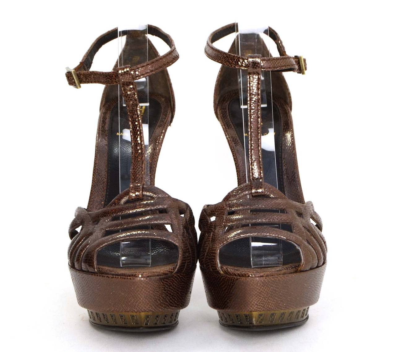 Fendi Bronze Strappy Platform Pumps
Features logo throughout platform
Made in: Italy
Color: Bronze
Composition: Metallic textile
Sole Stamp: Fendi Made in Italy Vero Cuoio 37 1/2
Closure/opening: Ankle buckle
Overall Condition: Excellent with