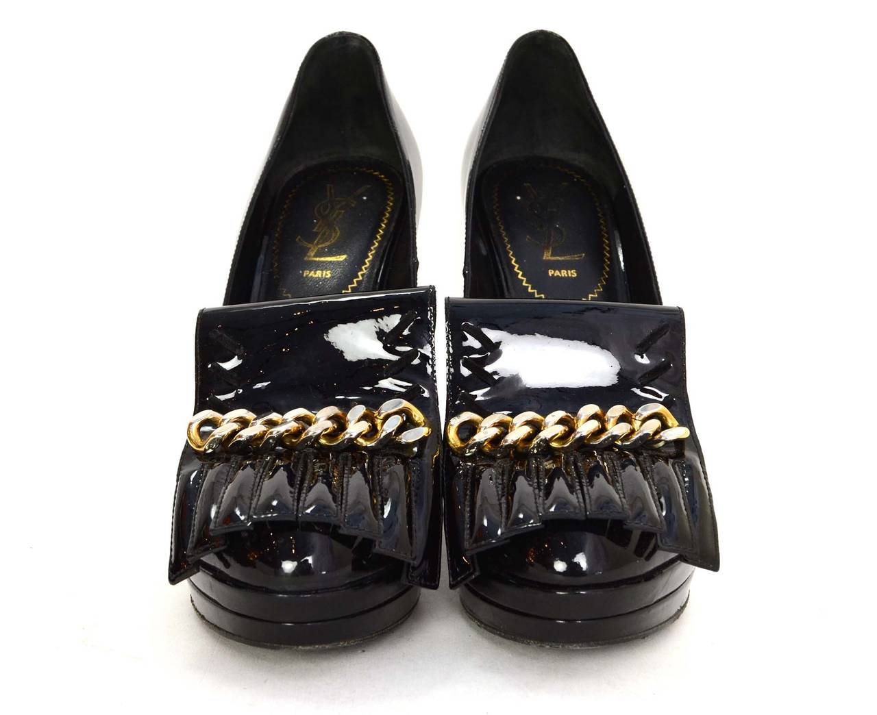 Yves Saint Laurent YSL Black Patent Wedges 
Features fringe and goldtone chain at toe
Made in: Italy
Color: Black and goldtone
Composition: Patent leather and metal
Sole Stamp: Yves Saint Laurent Made in Italy 37 1/2
Closure/opening: Slide