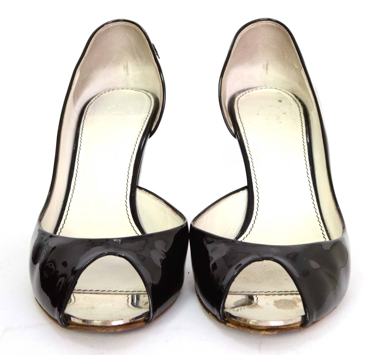 Chanel Black Patent Peep-Toe Pumps
Features a mirror/metal toe on interior of shoe
Made in: Italy
Color: Black
Composition: Patent leather and metal
Sole Stamp: CC 36 1/2 Made in Italy
Closure/opening: Slide on
Overall Condition: Excellent