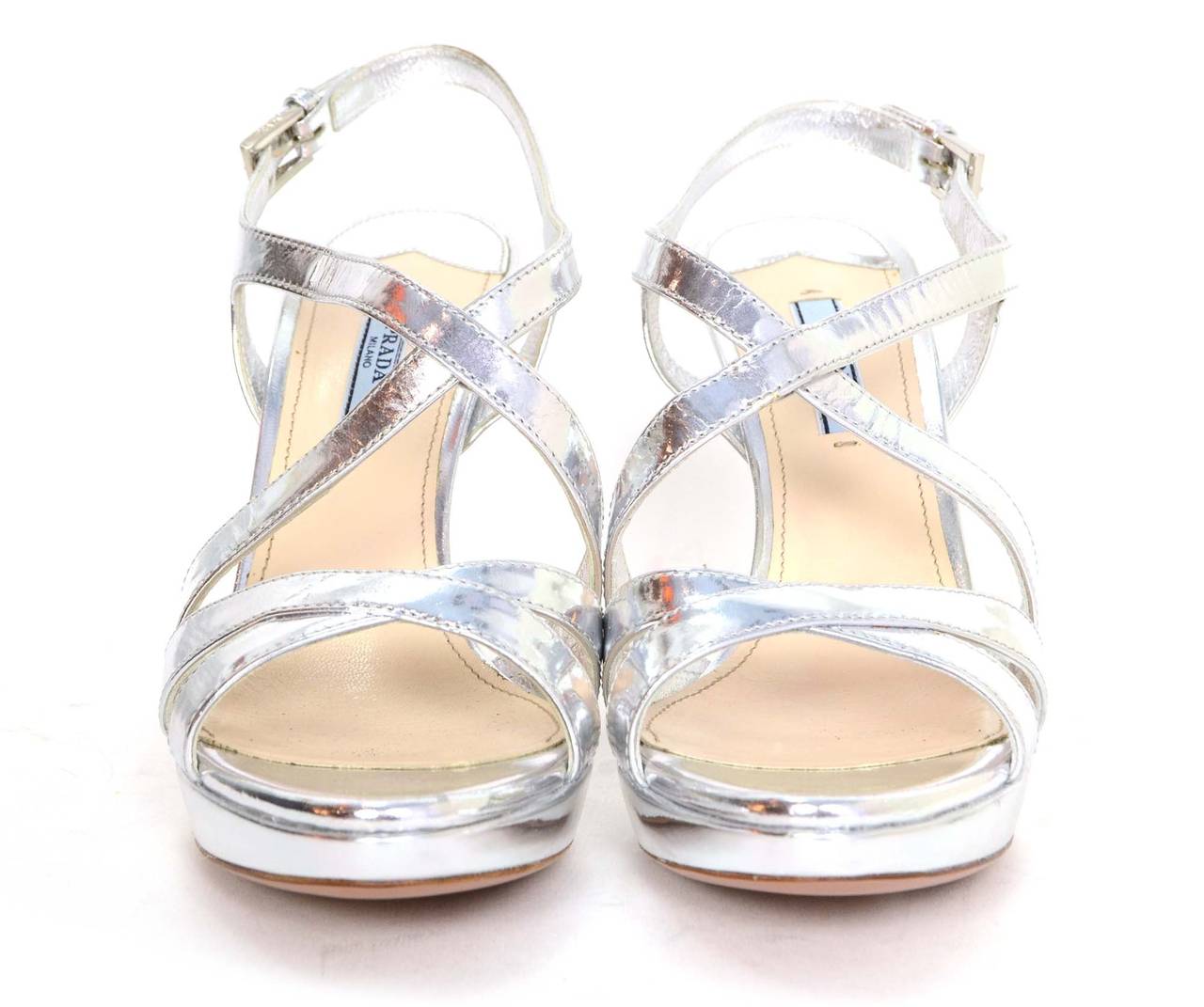 Prada Silver Glazed Leather Strappy Sandals 
Made in: Italy
Color: Silver
Composition: Glazed leather
Sole Stamp: Made in Italy 39 1/2 Prada
Closure/opening: Ankle buckle
Current Retail: $750 + tax
Overall Condition: Excellent with the