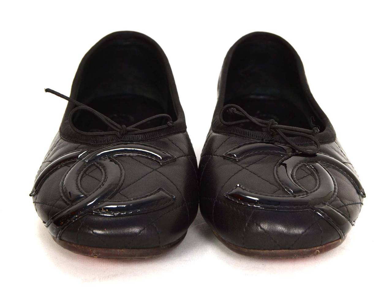 Chanel Black Quilted Leather Cambon Ballet Flats 
Features patent CC on toe with bow
Made in: Italy
Color: Black
Composition: Leather and patent leather
Sole Stamp: Chanel Made in Italy
Closure/opening: Slide on
Overall Condition: Excellent