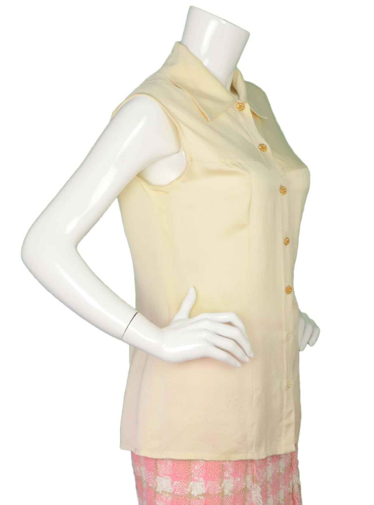 Chanel Beige Silk Sleeveless Button Down Top 
Features four goldtone camelia flower buttons with small pearl detailing in middle
Color: Beige and goldtone
Composition: Not given- believed to be 100% silk
Lining: None
Closure/opening: Front