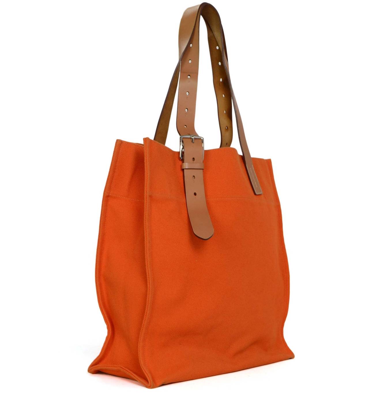 Hermes Orange Canvas Etriviere Tote Bag
Features adjustable leather shoulder straps
Made in: France
Year of Production: 2011
Color: Orange, tan and silvertone
Hardware: Palladium
Materials: Canvas, leather and metal
Lining: Orange