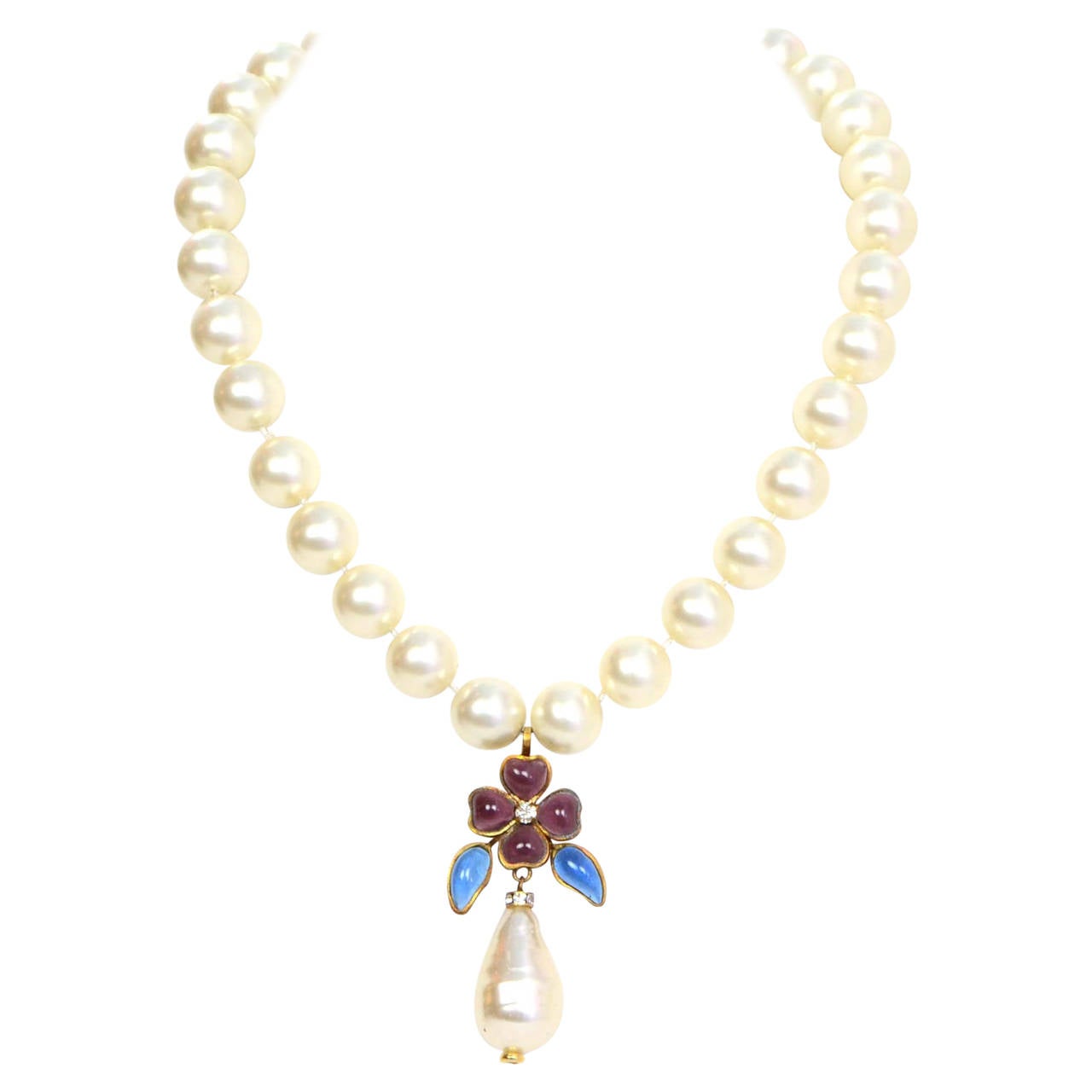 Chanel Vintage '83 Pearl & Gripoix Necklace
Features faux pearl, gripoix and rhinestone tear drop pendant

Made in: France
Year of Production: 1983
Stamp: Chanel CC 1983
Closure: Hook closure
Color: Ivory, purple, blue and goldtone
Materials: Faux