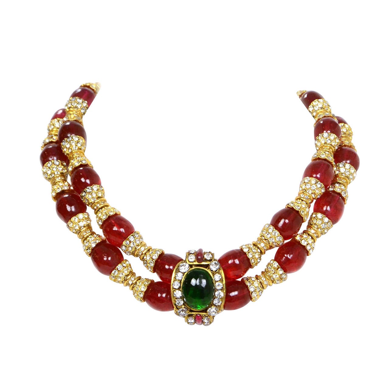 Chanel Vintage '83 Red Gripoix and Rhinestone Double Tier Necklace
Features green gripoix and rhinestone pendant at center
Made in: France
Year of Production: 1983
Stamp: Chanel CC 1983
Closure: Hook closure
Color: Red, green and